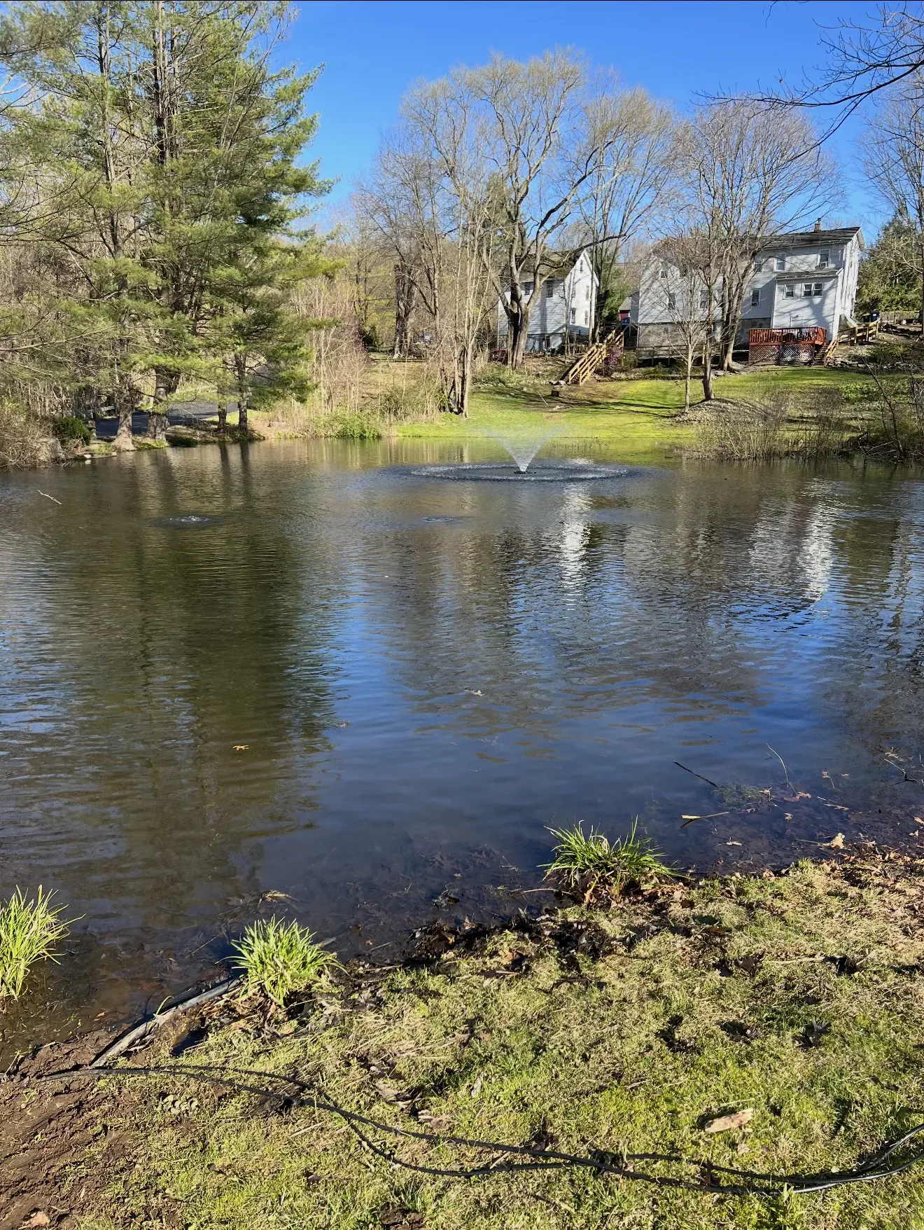 Large pond with an aerating fountain in spring