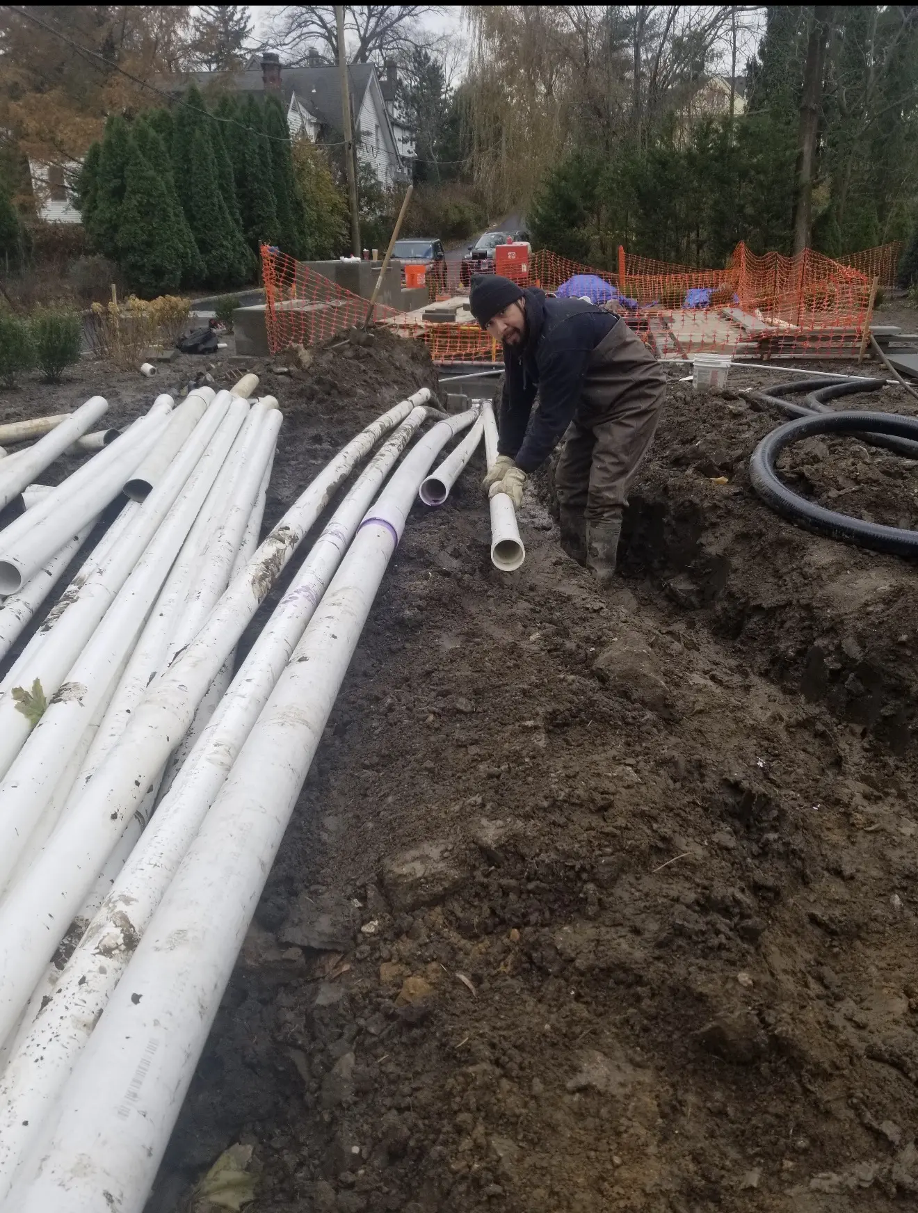 Crew installing pond plumbing lines on site